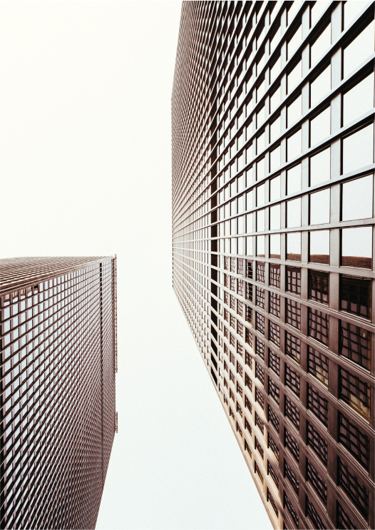 Looking up at two office buildings